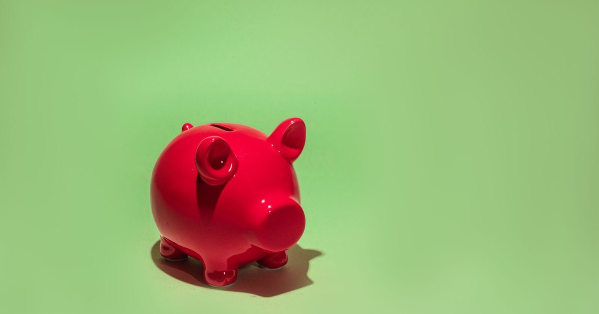 A red piggy bank on a green background